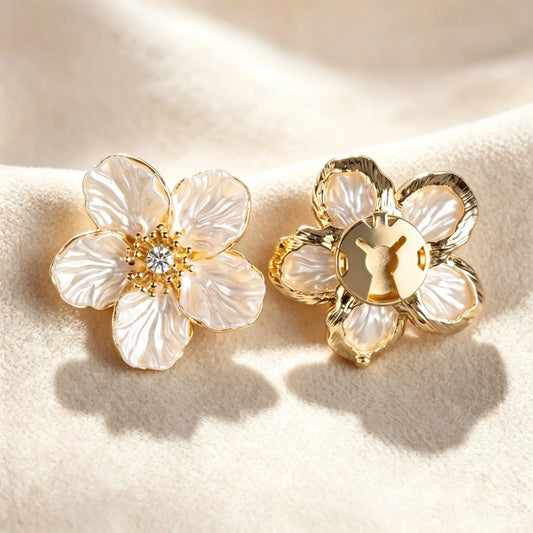 A pair of unisex camellia button covers that can also be used as cufflinks or collar pins, highlighting the versatile and premium materials.