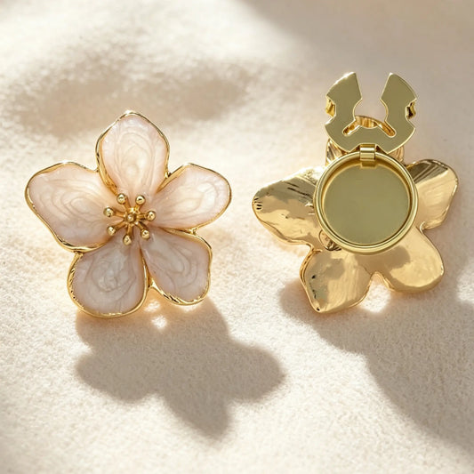Light luxury blush pink enamel floral button cover featuring gold edges and a subtle swirl texture. The right piece displays the open gold hinge mechanism, designed for a quick and elegant shirt cuff upgrade without sewing.