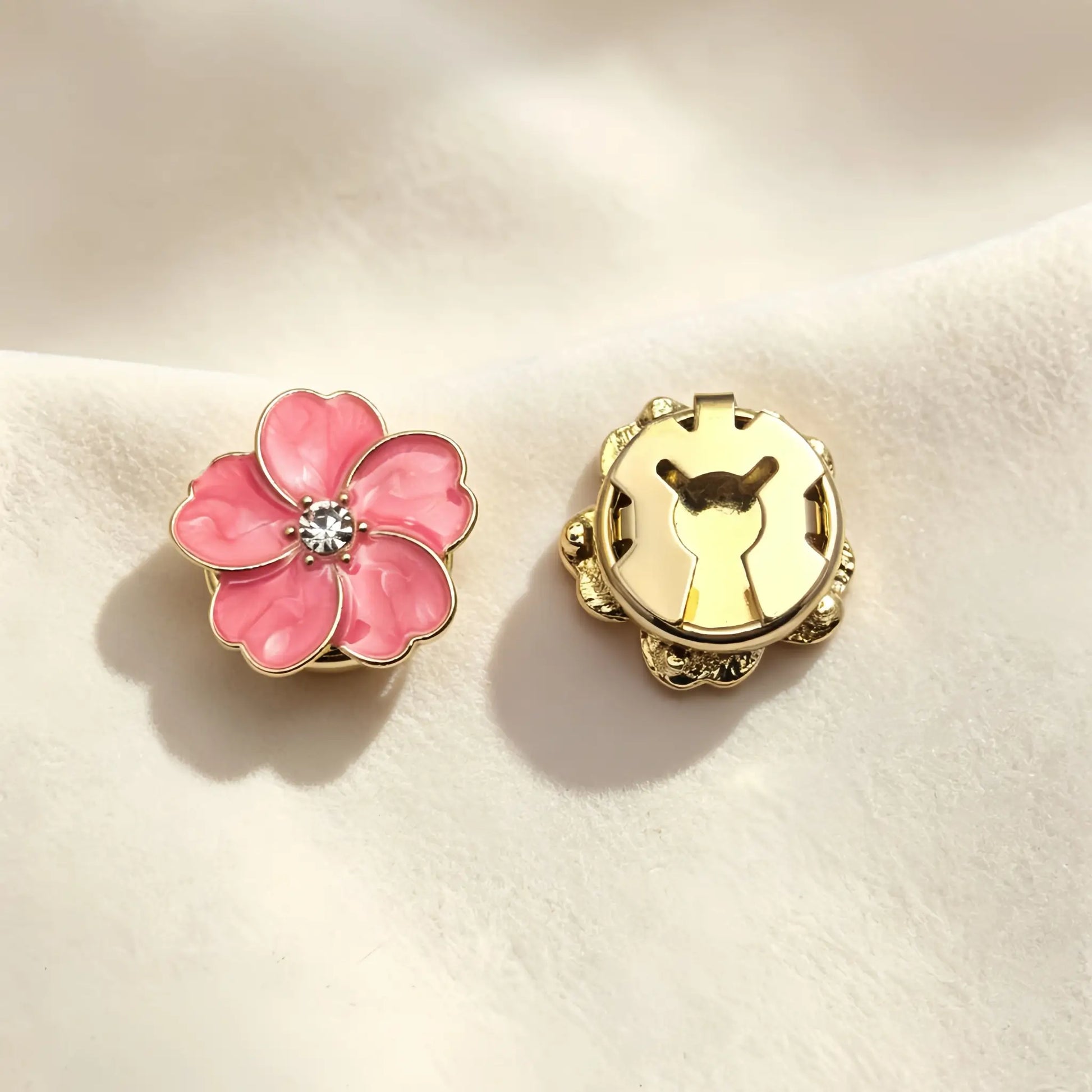 A pair of beautiful blush pink marbled enamel button covers. The image focuses on the secure closed gold clip mechanism on the back, offering a refined vintage-style faux cufflink solution.