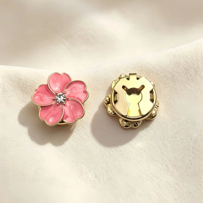 A pair of beautiful blush pink marbled enamel button covers. The image focuses on the secure closed gold clip mechanism on the back, offering a refined vintage-style faux cufflink solution.