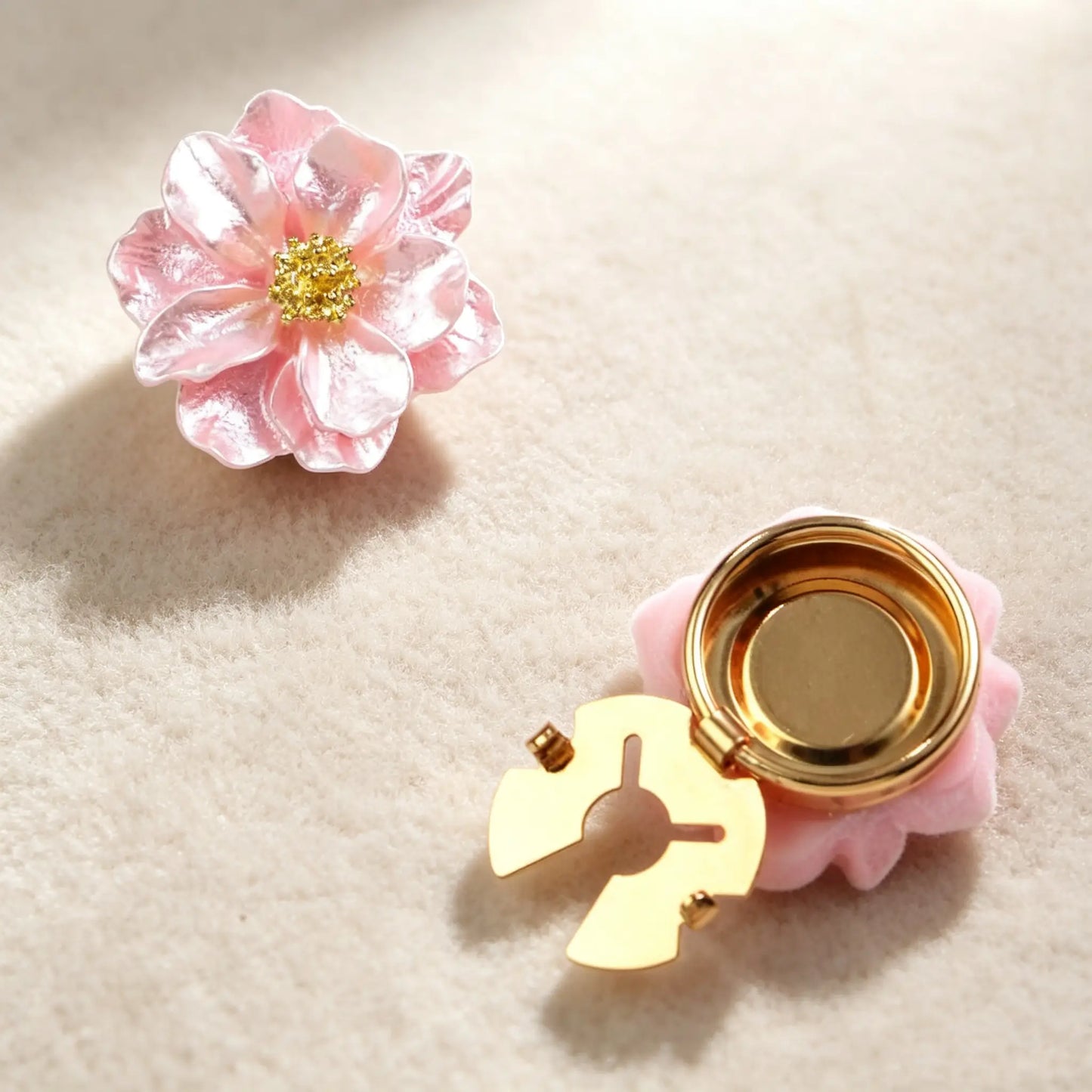 Light luxury blush pink floral button cover with a shimmering finish and detailed gold center. Features both the front aesthetic and the open gold clasp mechanism, perfect for adding an elegant touch to cuffs.