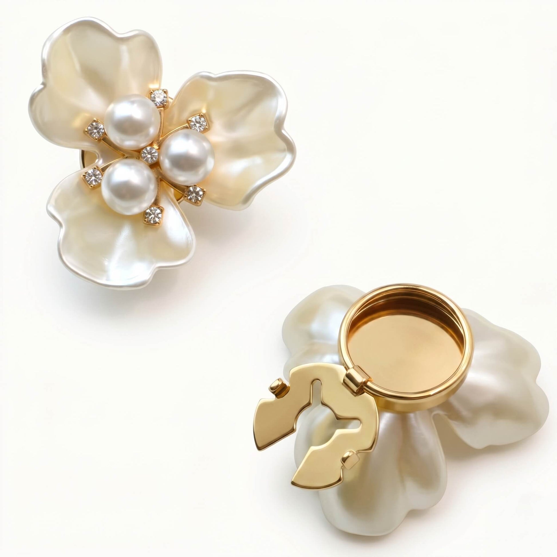 Elegant cream floral button cover with a pearl and crystal center, featuring a gold-toned clip-on mechanism for no-sew shirt styling and wardrobe renewal.