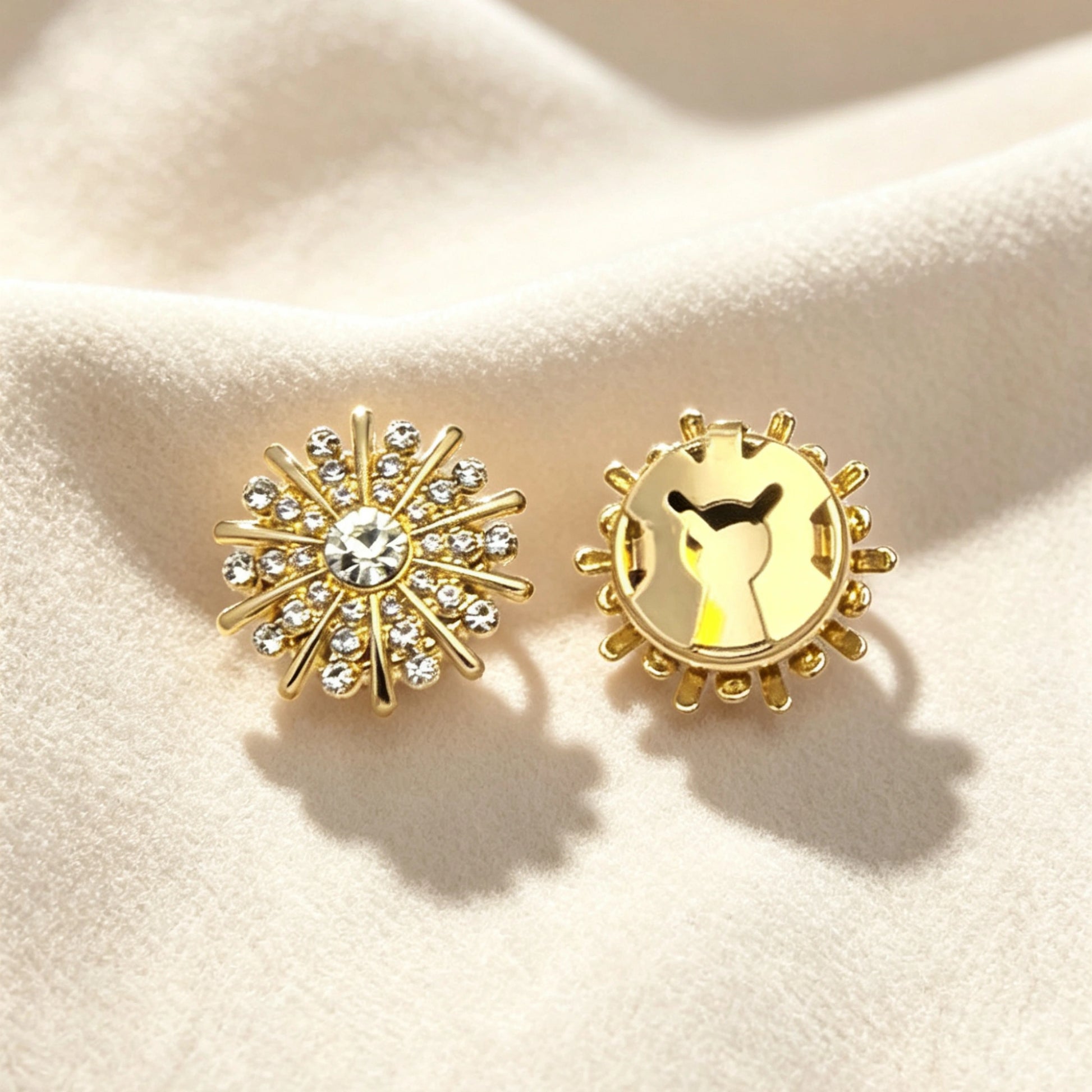 Detailed view of a vintage crystal starburst button cover resting on a soft cream background. The right side shows the secure closed gold backing, ensuring a flawless fit as an elegant evening cuff accessory.