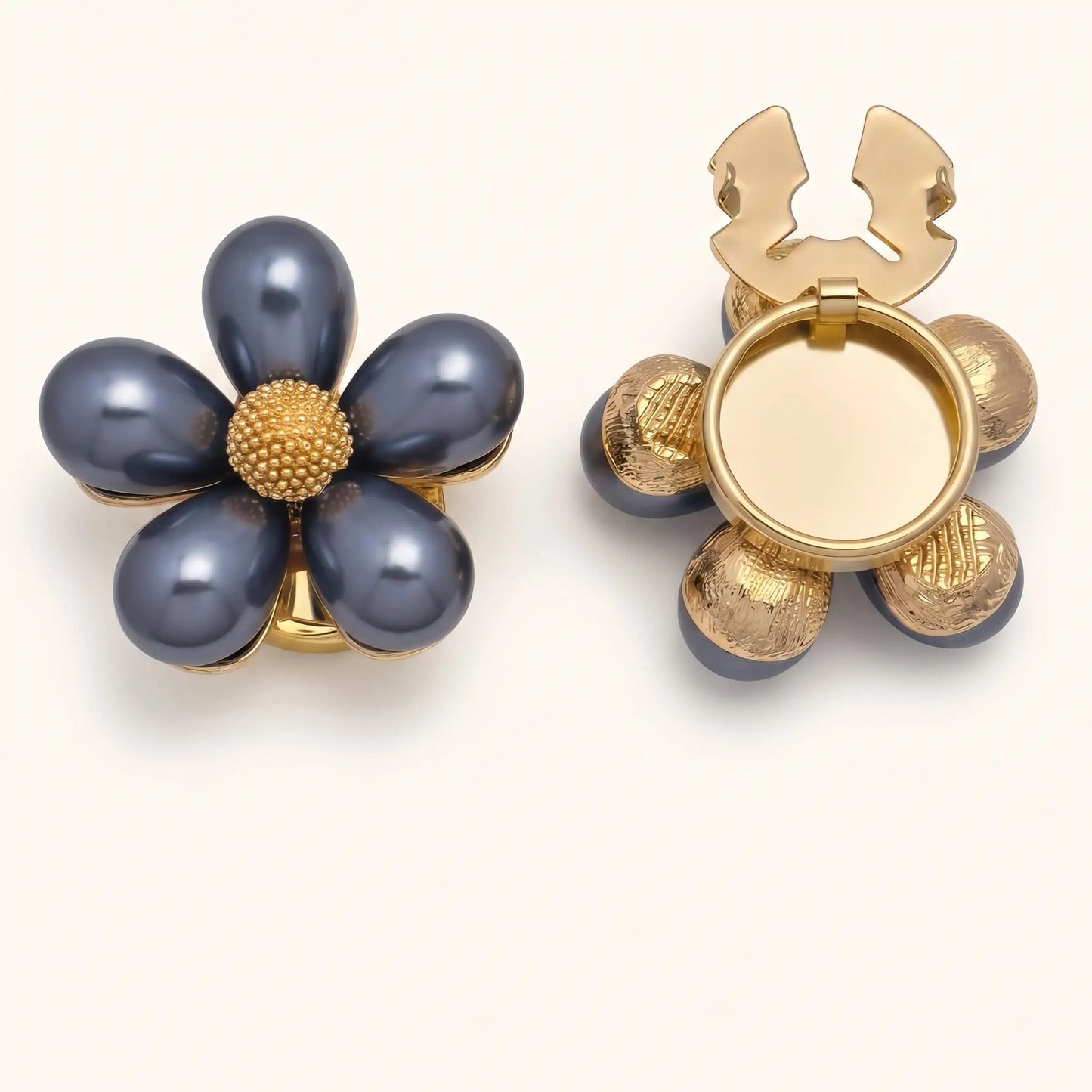 Elegant dark grey pearl floral button cover with a textured gold center. The right side shows the open gold hinge mechanism, designed to be easily attached as a light luxury cuff accessory.