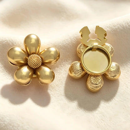 Glossy gold floral button cover with a textured gold core. The image highlights the open back clasp mechanism, demonstrating how it easily snaps onto shirt cuffs for a French-style finish without sewing.