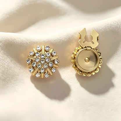 Elegant round gold medallion button cover featuring concentric circles of sparkling rhinestones. Shown with the gold attachment clip fully open, demonstrating an effortless and brilliant faux cufflink solution.