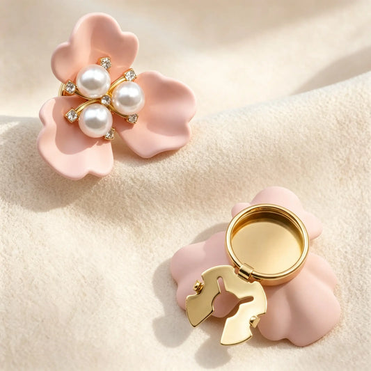 Gentle matte blush pink three-petal floral button cover with a beautiful pearl and rhinestone core. Shown with the gold open clasp mechanism on the back, offering a refined detachable faux cufflink solution for everyday elegance.