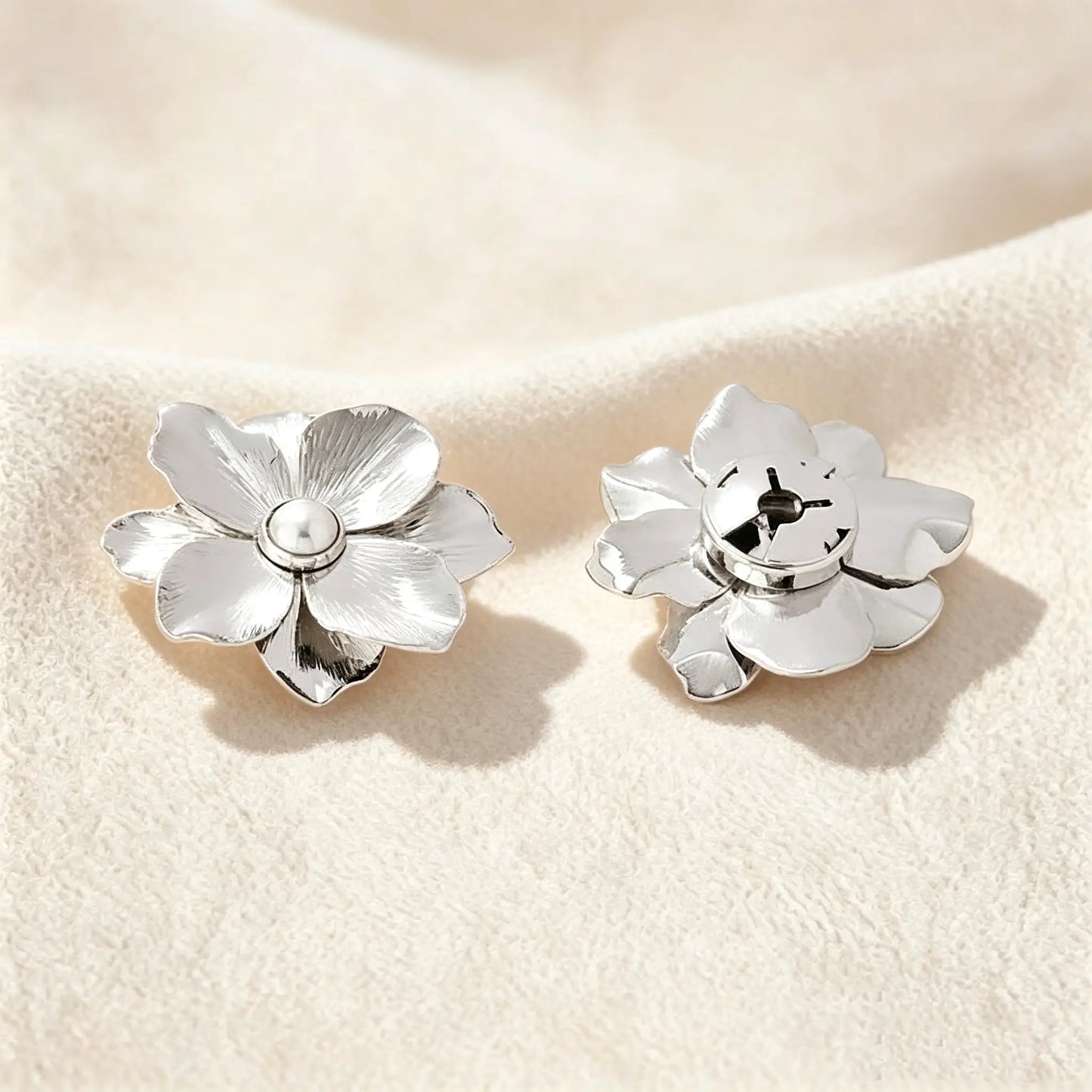 Detailed view of a refined silver floral button cover. The right side shows the securely closed clip mechanism, ensuring a 1:1 standard button scale for a sophisticated, no-sew faux cufflink experience.