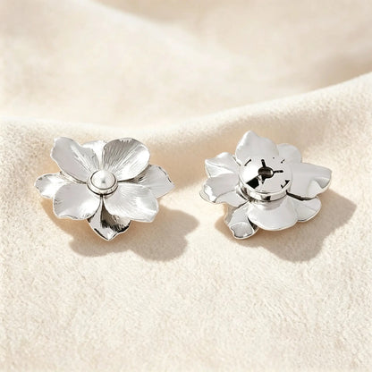 Detailed view of a refined silver floral button cover. The right side shows the securely closed clip mechanism, ensuring a 1:1 standard button scale for a sophisticated, no-sew faux cufflink experience.