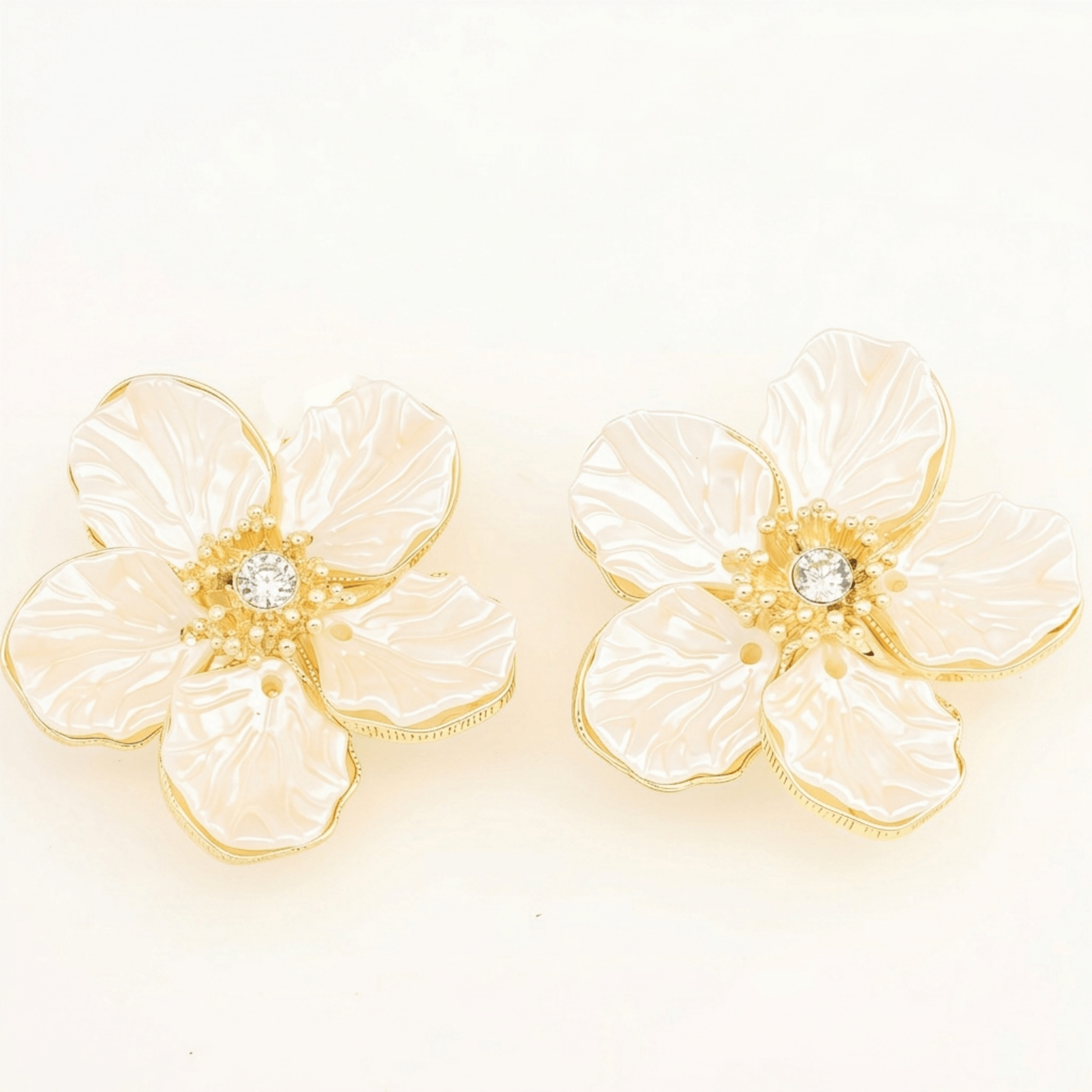 A pair of unisex camellia button covers that can also be used as cufflinks or collar pins, highlighting the versatile and premium materials.