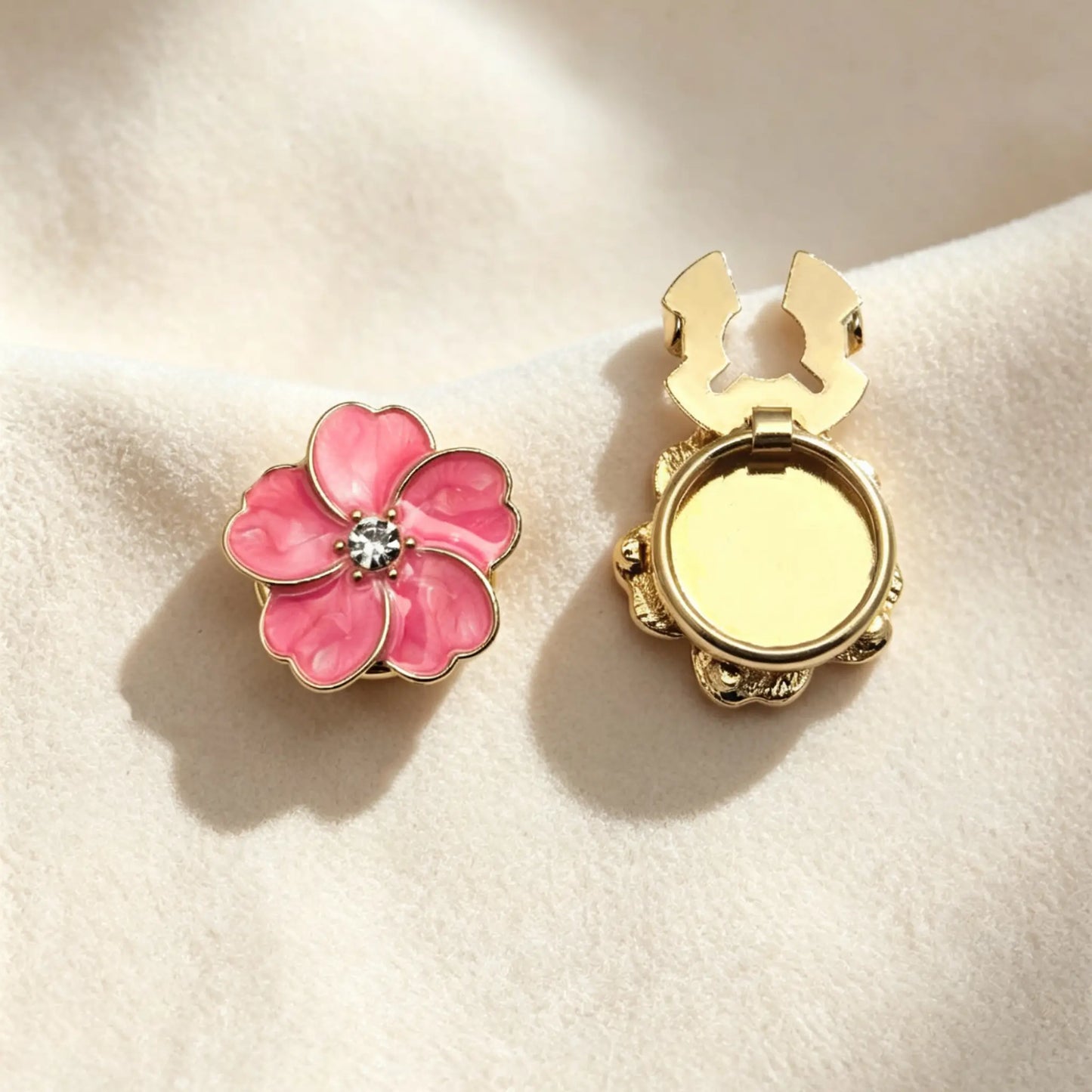 Light luxury rose pink enamel floral button cover with a beautiful swirl effect and gold borders. The right piece shows the open gold attachment clip, demonstrating an effortless no-sew cuff upgrade.