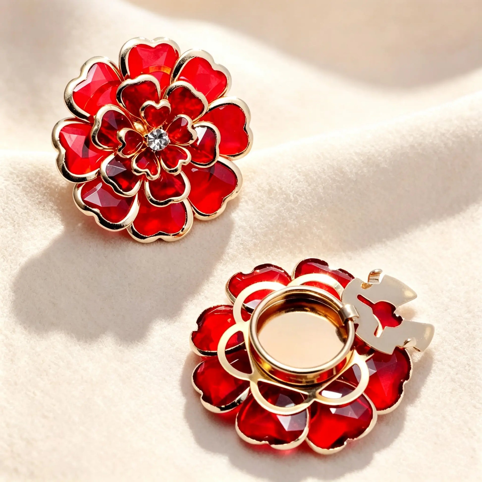 Vibrant ruby red layered crystal floral button cover with a sparkling rhinestone core. Paired with a view of the gold open attachment clip, ideal for an instant elegant shirt upgrade.