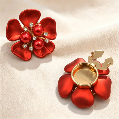 Vibrant satin red floral button cover featuring three matching red pearls in the center. Shows the gold open hinge mechanism, demonstrating a seamless French cuff styling solution.