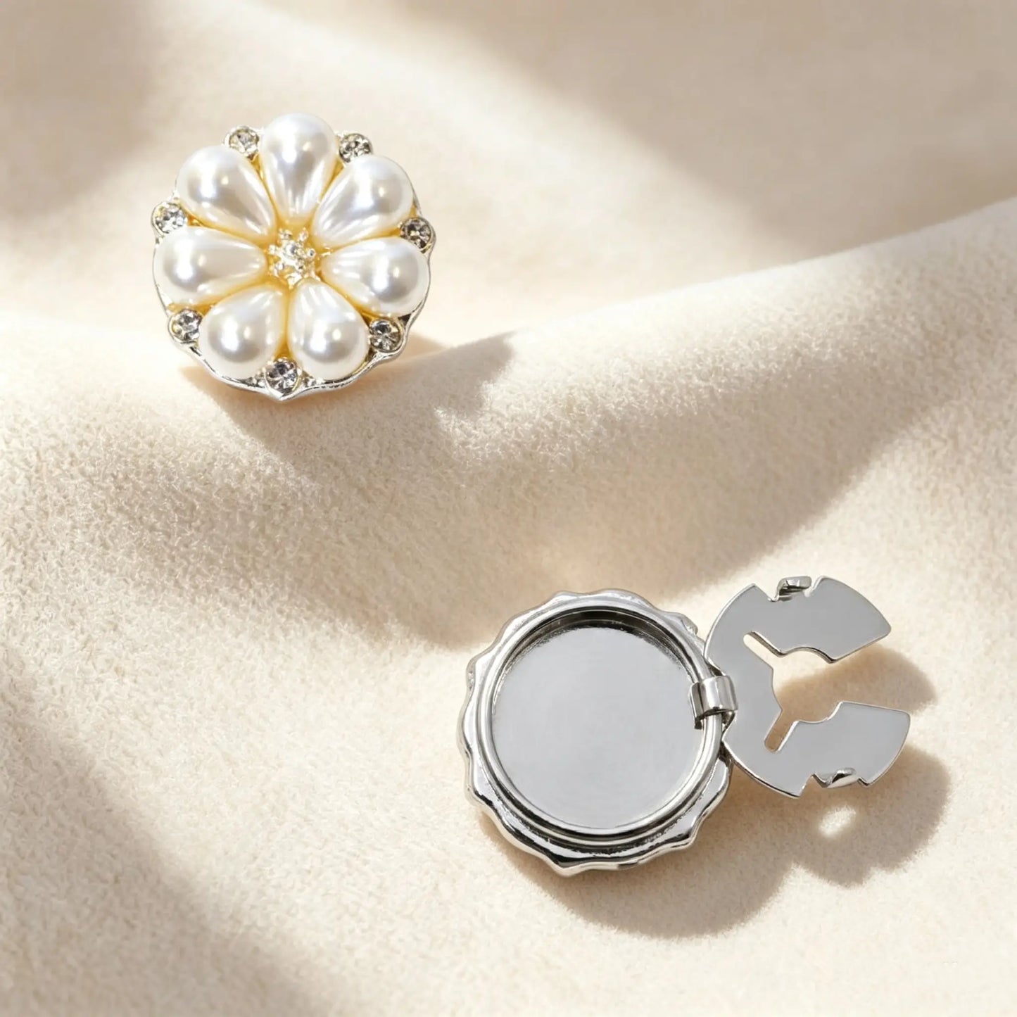 Silver pearl flower button cover with a functional hinge design, providing a sophisticated French style accent to standard shirt buttons.