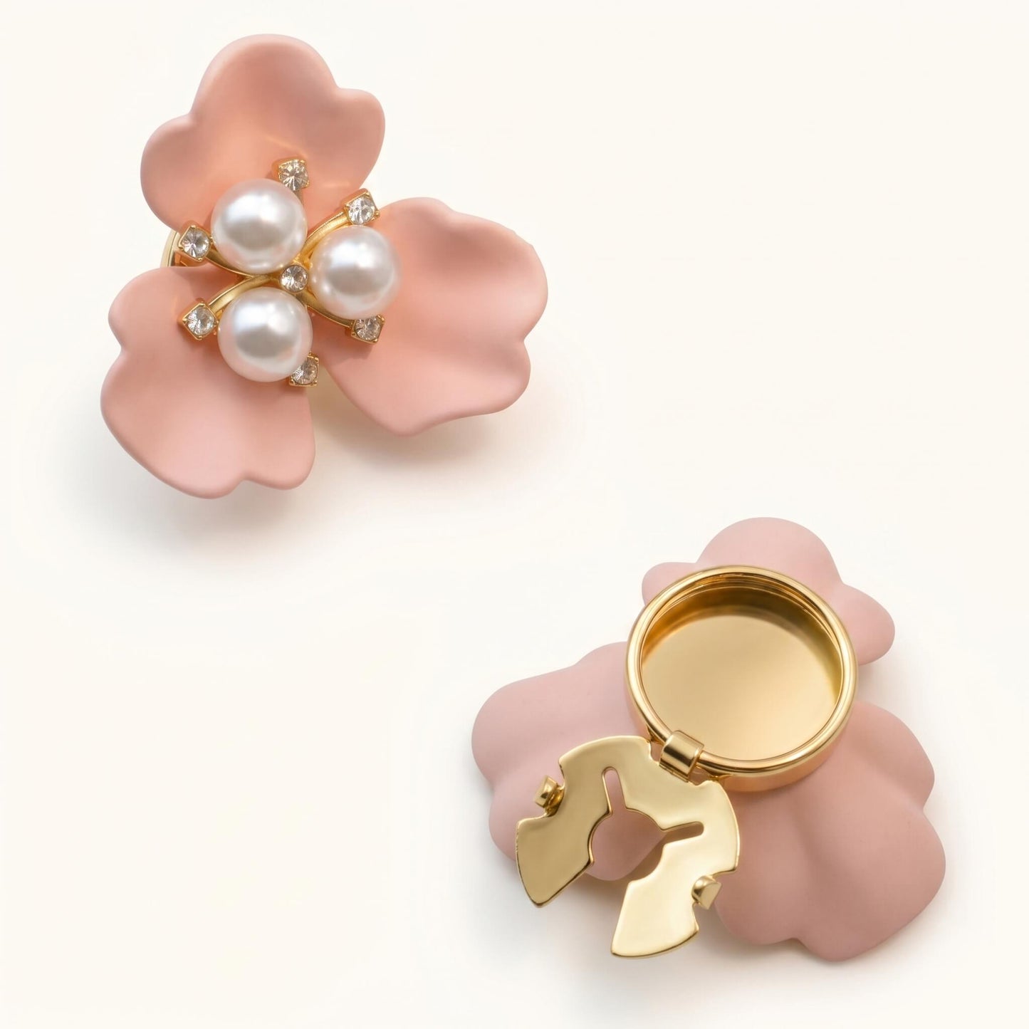 Soft pink floral button cover with a shimmering pearl center, showcasing the functional clip-on design for a quick and feminine upgrade to professional attire.