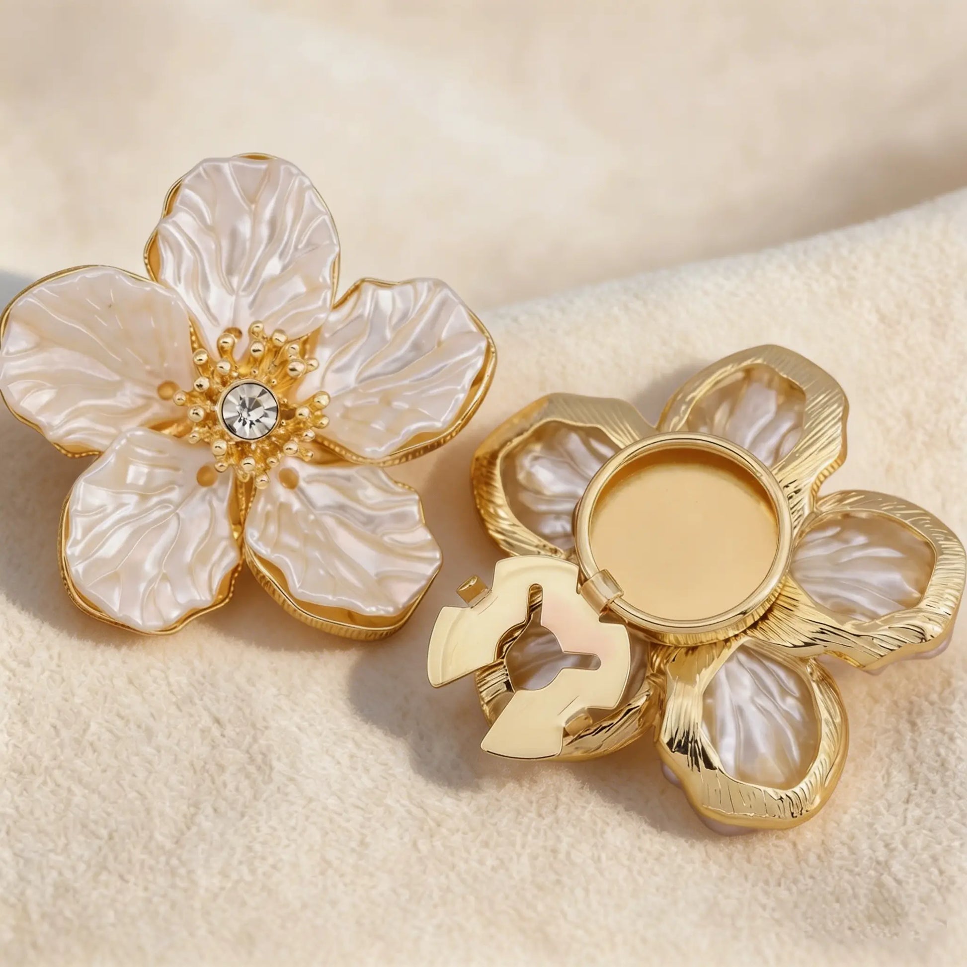 A pair of unisex camellia button covers that can also be used as cufflinks or collar pins, highlighting the versatile and premium materials.