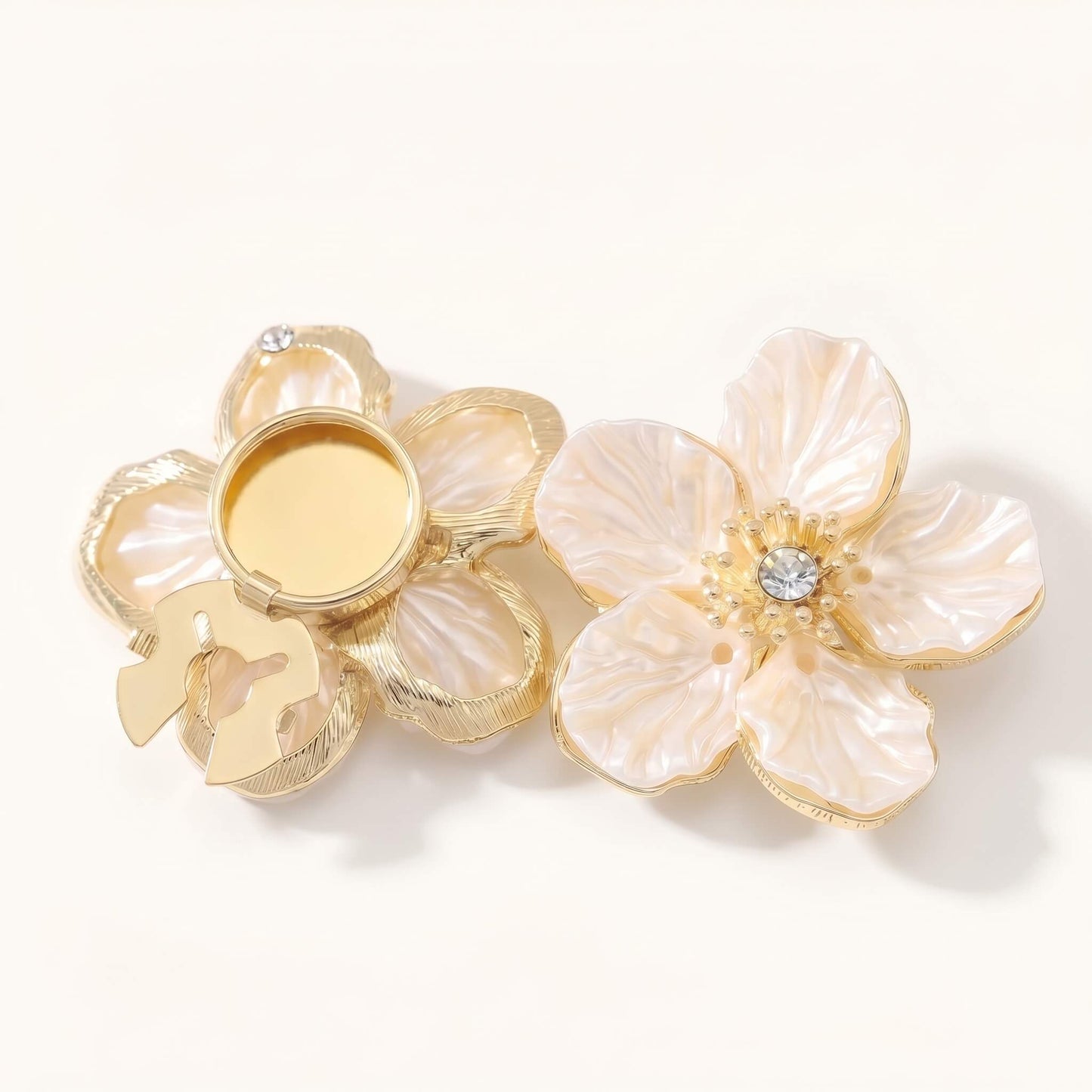 Detailed view of the no-sew snap buckle mechanism on an elegant camellia pearl button cover, showing how it securely clips onto shirt buttons.