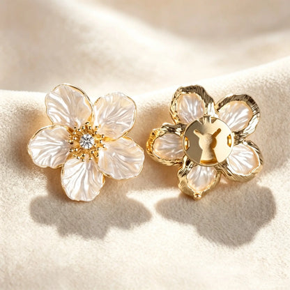 A pair of unisex camellia button covers that can also be used as cufflinks or collar pins, highlighting the versatile and premium materials.