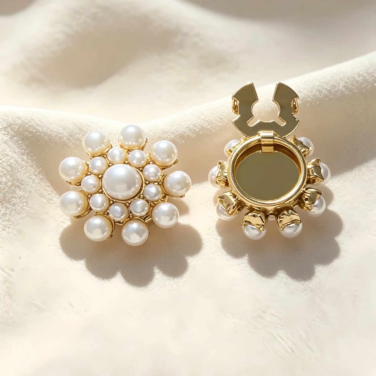 Elegant vintage-style button cover featuring a multi-layered white pearl cluster in a sunflower design with a gold base. The right piece shows the open gold hinge mechanism, perfect for a seamless, no-sew French cuff upgrade.
