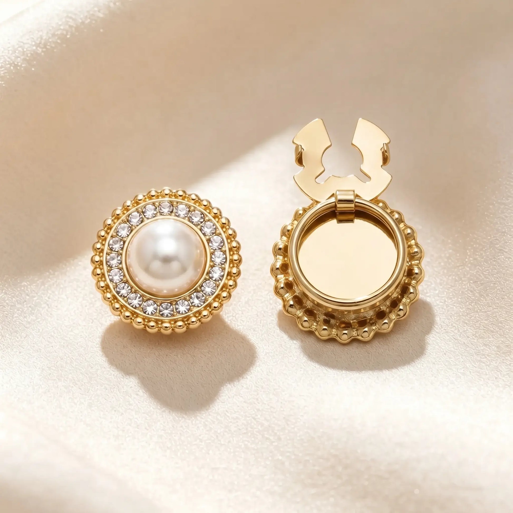 Vintage-style round button cover featuring a large central pearl surrounded by a halo of sparkling rhinestones and an outer border of mini pearls. The open gold hinge mechanism is displayed, offering a classic faux cufflink solution.