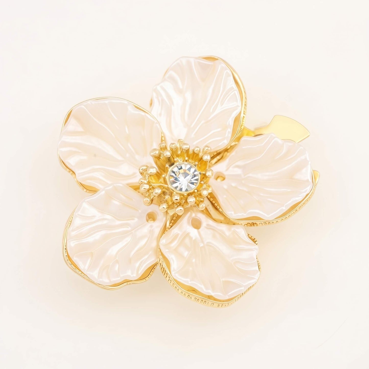 A premium white camellia button cover featuring imitation pearl petals and a 14K gold-plated frame with a shiny cubic zirconia center.