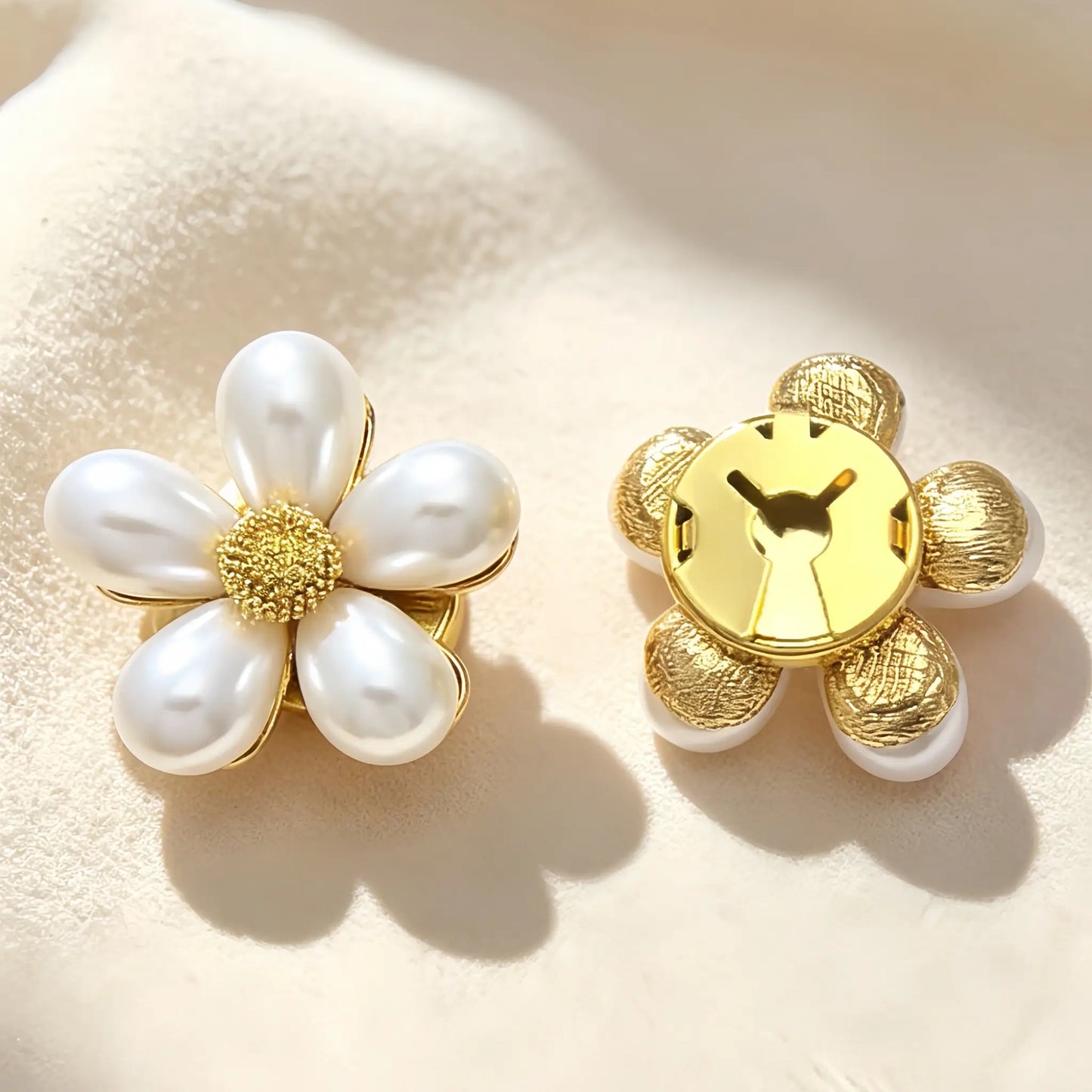 A pair of light luxury white pearl floral button covers on a minimalist background. The right piece illustrates the closed gold backing, ensuring a secure and elegant fit when used as a faux cufflink.