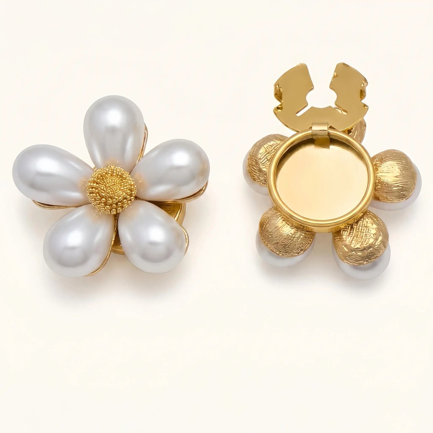 Classic white pearl floral button cover featuring a delicate textured gold center. Paired with a view of the open gold clip mechanism, ideal for achieving an effortless French-style cuff accessory look.