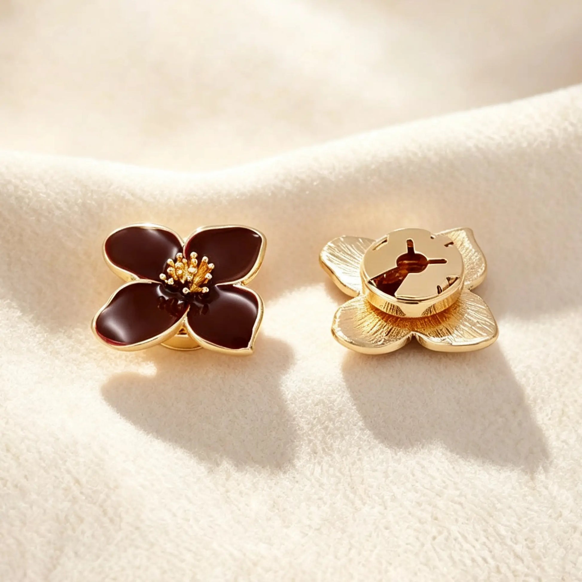 Close-up of a deep burgundy enamel floral button cover. The right piece displays the securely closed attachment mechanism and its textured gold finish, guaranteeing a refined, realistically scaled upgrade for sophisticated wardrobe essentials.